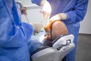 Bald man undergoing dental procedure